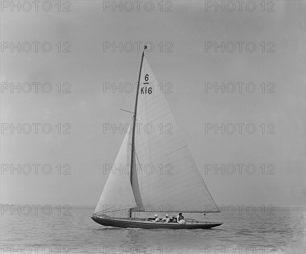 The 6 Metre class boat 'Jean' (K16) sailing close-hauled, 1921. Creator: Kirk & Sons of Cowes.