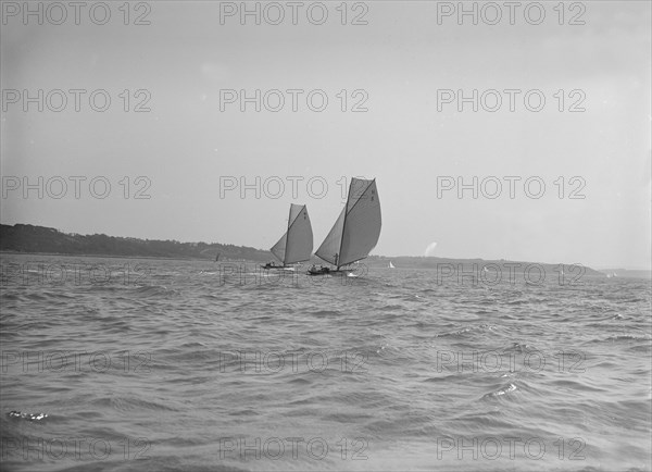 The 8 Metre sailing yachts 'Endrick' and 'Spero' racing downwind, 1911. Creator: Kirk & Sons of Cowes.