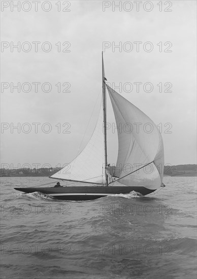 The 7 Metre yacht 'Pinaster' (K8) sailing with spinnaker, 1913. Creator: Kirk & Sons of Cowes.