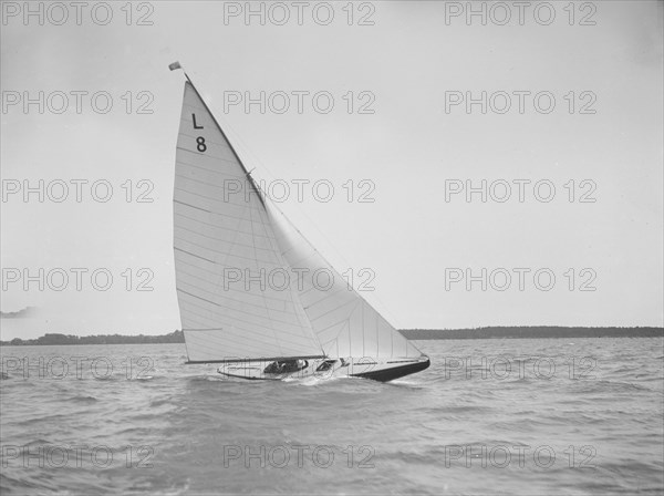 The 6 Metre 'Scotia IV' sailing upwind on a fine day, 1913. Creator: Kirk & Sons of Cowes.