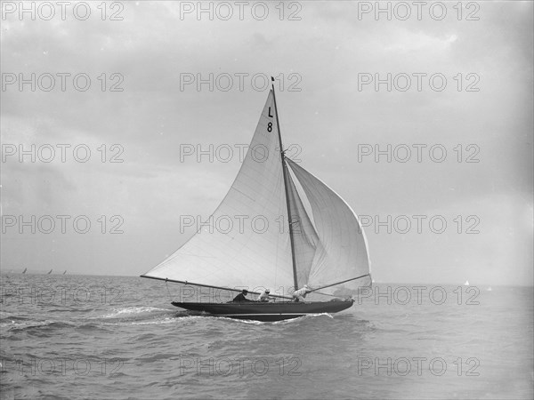 'Scotia IV' running downwind with spinnaker, 1913. Creator: Kirk & Sons of Cowes.