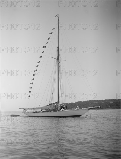 The 40-rater cutter 'Carina' at anchor with flags, 1911. Creator: Kirk & Sons of Cowes.