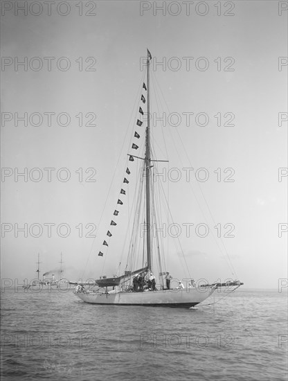 The 40-rater cutter 'Carina' at anchor with flags, 1911. Creator: Kirk & Sons of Cowes.