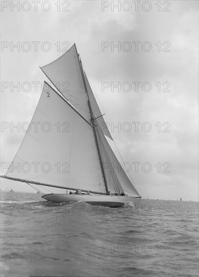 The 40-rater cutter 'Carina' sailing close-hauled, 1911. Creator: Kirk & Sons of Cowes.