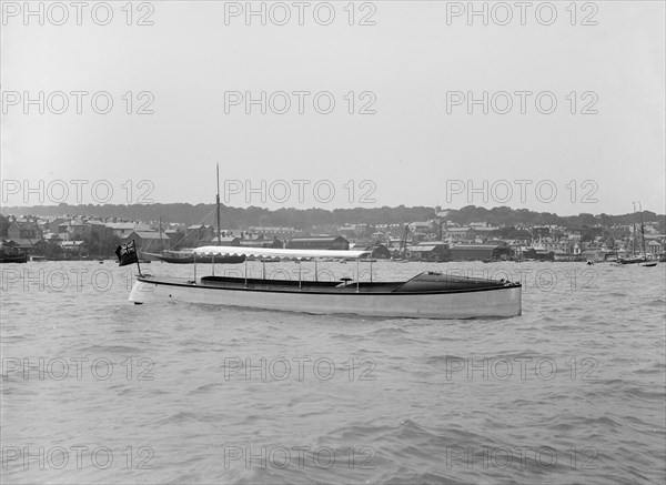 Saunders' motor launch at anchor, 1914. Creator: Kirk & Sons of Cowes.