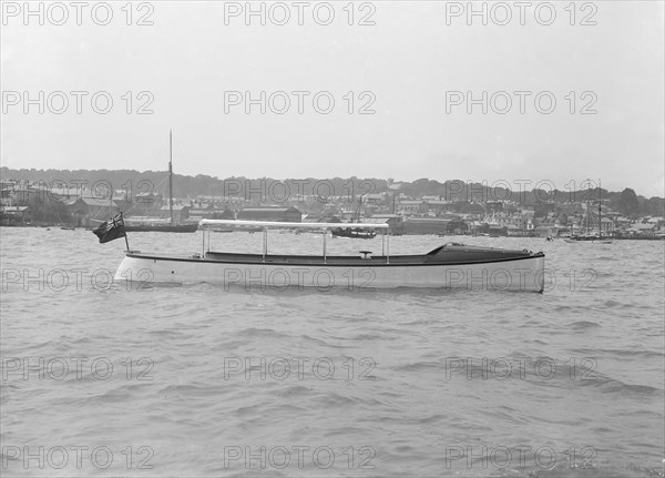 Saunders' motor launch at anchor, 1914. Creator: Kirk & Sons of Cowes.