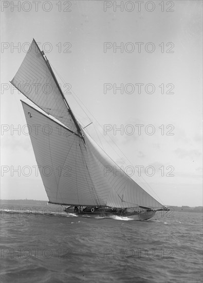 The 40-rater cutter 'Carina' heeling in good wind, 1911. Creator: Kirk & Sons of Cowes.