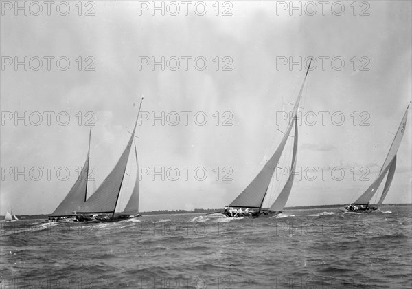 A group of 12 Metres sailing yachts racing on windward leg in good wind, 1933. Creator: Kirk & Sons of Cowes.