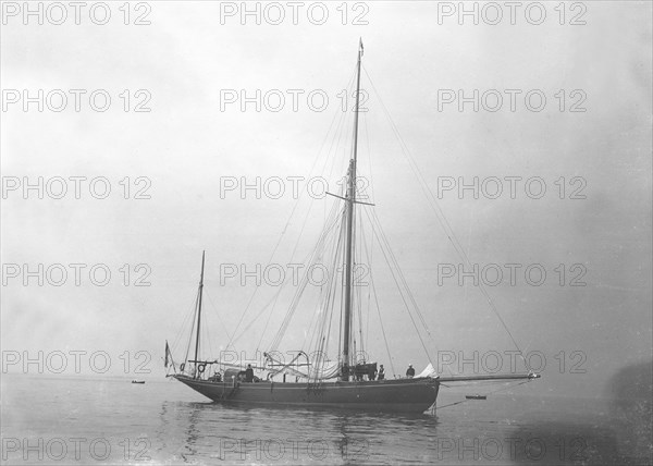 The gaff yawl 'Coral' at anchor, 1922. Creator: Kirk & Sons of Cowes.