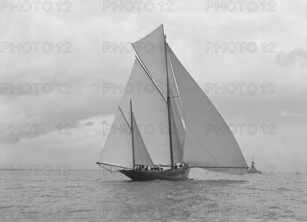 The yawl 'Harbinger' running downwind, 1922. Creator: Kirk & Sons of Cowes.