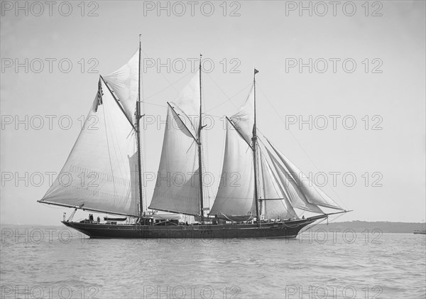 The three-mast auxiliary schooner 'Invincible', 1911. Creator: Kirk & Sons of Cowes.