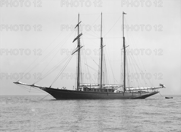 The auxiliary schooner 'La Cigale' at anchor, 1913. Creator: Kirk & Sons of Cowes.