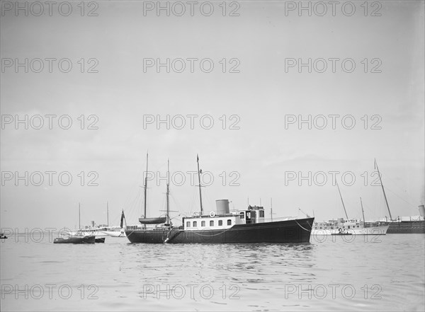 The twin screw 80ft motor yacht 'Bystander' at anchor, 1934. Creator: Kirk & Sons of Cowes.