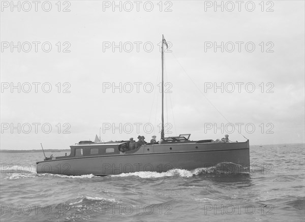 The motor yacht 'Cygnet' under way, 1922. Creator: Kirk & Sons of Cowes.