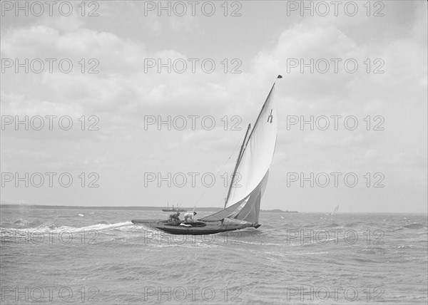 The 6 Metre class 'Ejnar' sailing downwind, 1911. Creator: Kirk & Sons of Cowes.