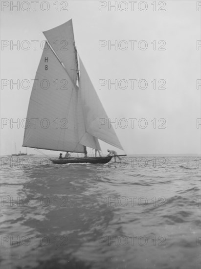 Mrs GA Shenley at the helm of the 8 Metre class sailing yacht 'Spero' (H8). Creator: Kirk & Sons of Cowes.