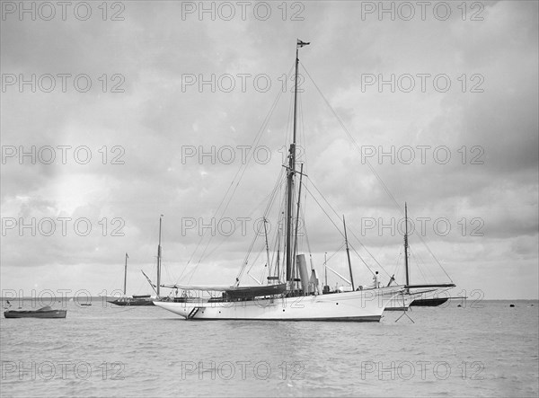 The cutter 'Yolande' at anchor, 1912. Creator: Kirk & Sons of Cowes.