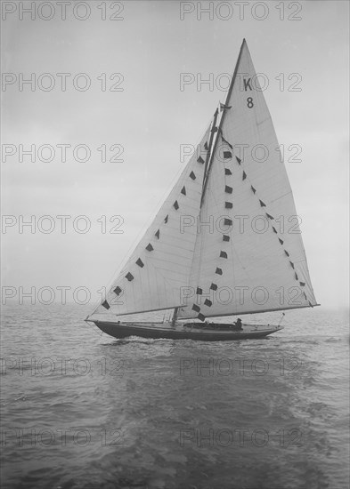 The 7 Metre sailing yacht 'Pinaster' (K8) with prize flags, 1912. Creator: Kirk & Sons of Cowes.