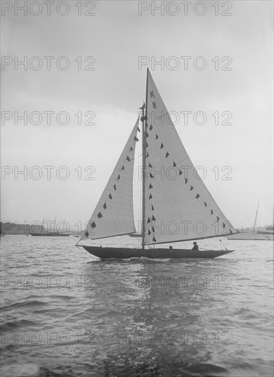 The 7 Metre sailing yacht 'Pinaster' (K8) with prize flags, 1912. Creator: Kirk & Sons of Cowes.