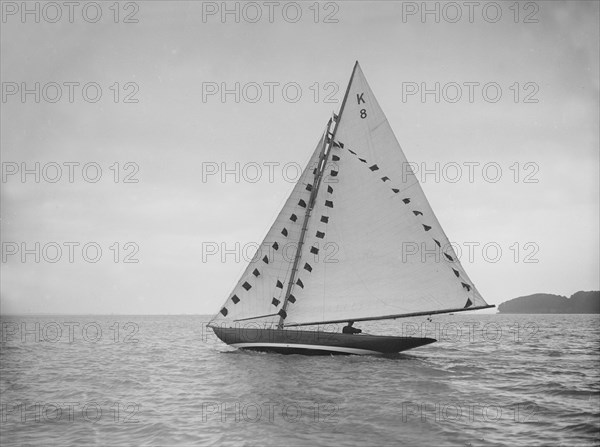 The 7 Metre sailing yacht 'Pinaster' (K8) with prize flags, 1912. Creator: Kirk & Sons of Cowes.