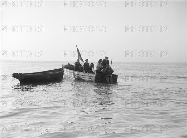 Preparing diver for sea salvage, 1912. Creator: Kirk & Sons of Cowes.