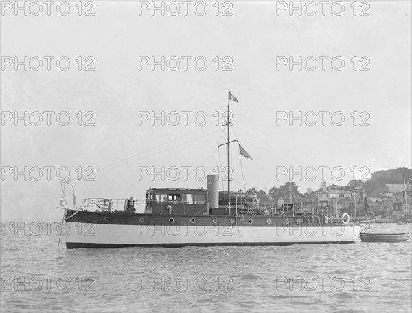 The 28 ton motor yacht 'Edina' at anchor, 1921. Creator: Kirk & Sons of Cowes.