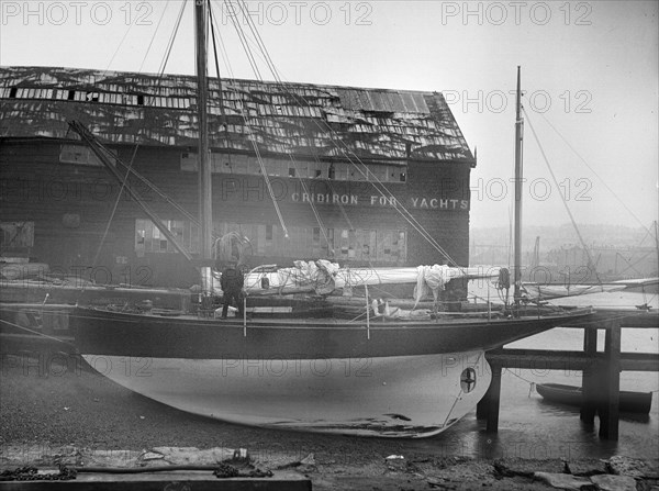 The yawl 'Banzai' dried out at boatyard mooring, 1912. Creator: Kirk & Sons of Cowes.