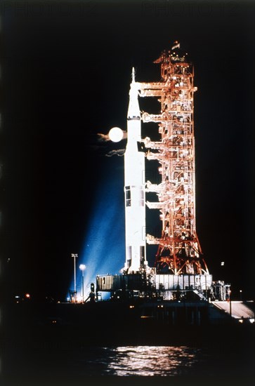 Apollo 9 Saturn V rocket with full moon, 1969.  Creator: NASA.