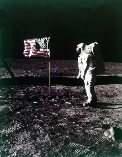 Buzz Aldrin stands next to the American flag on the surface of the Moon, July 1969. Creator: Neil Armstrong.