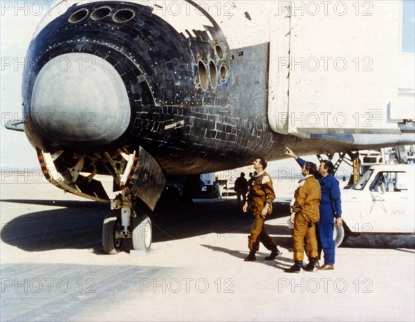 Inspecting heat tiles, second Space Shuttle flight, November 1981. Creator: NASA.