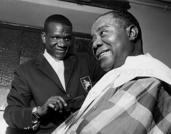 Louis Armstrong having haircut in Hammersmith, London, 1962.