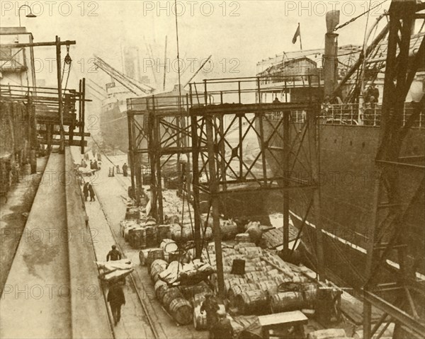 Unloading Foodships at the Royal Albert Docks, London', c1930.