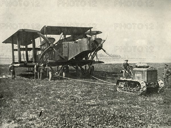 A Small Motor Tractor Getting a Huge R.A.F. Bombing Machine into Position...', (1919).