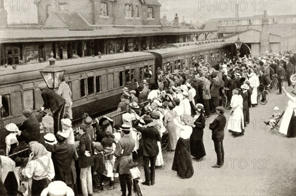 Crowds waving off troops leaving to fight in the First World, War