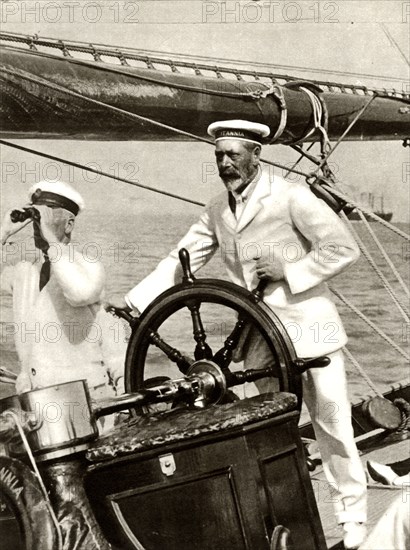 King George V at the wheel of of his yacht, Britannia