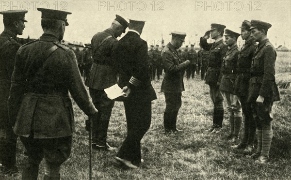 King George V decorates British personnel, Belgium, First World War, 1914-1918, (c1920). Creator: Unknown.