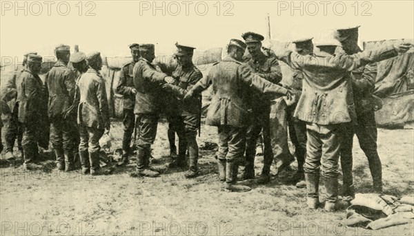 'After the Battle: searching German prisoners of war...', First World War, c1916, (c1920).  Creator: Unknown.