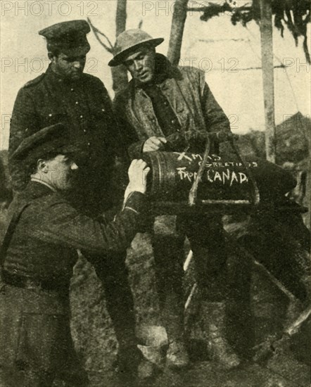 Soldiers write Christmas greetings on a shell, Western Front, First World War, c1916, (c1920). Creator: Unknown.