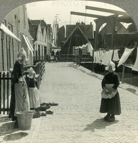 'Washday in Volendam, Netherlands - Shoes Large and Small and Some Who Wear Them', c1930s. Creator: Unknown.