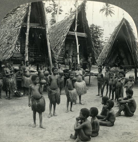 'Carrying Water in Coconut Shells - A Village Scene in New Guinea', c1930s. Creator: Unknown.