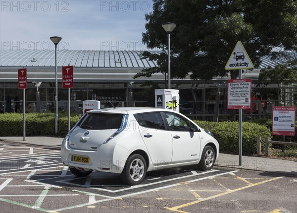 Nissan Leaf at elctric charging point 2015. Creator: Unknown.