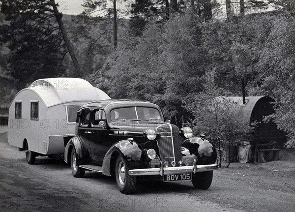 1936 Oldsmobile Eight with caravan in Scotland. Creator: Unknown.