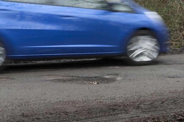 Pot holes in road surface 2017. Creator: Unknown.