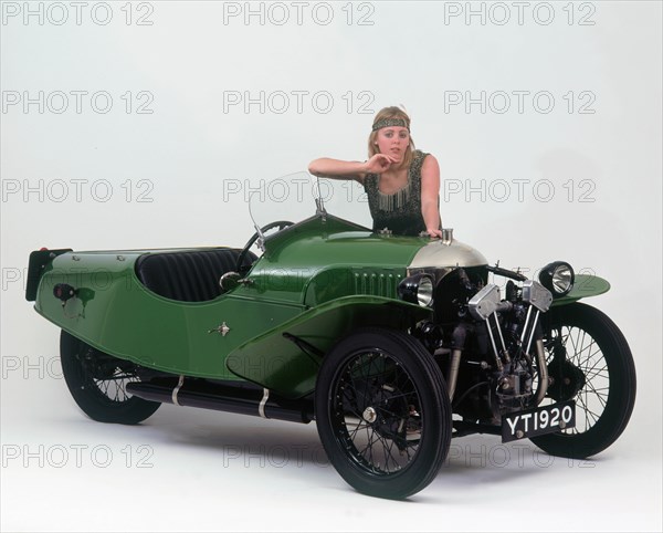 1927 Morgan Aero 3 wheeler with female "flapper" model. Creator: Unknown.