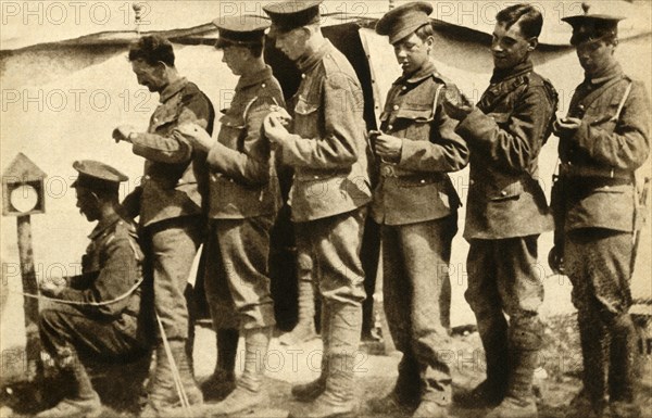 British soldiers synchronising their watches on the front line, First World War, 1914-1918, (1933). Creator: Unknown.
