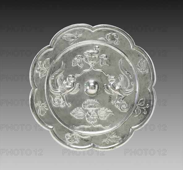 Lobed Mirror with Paired Phoenixes, a Nestling Bird, and a Lotus Blossom, 700s. Creator: Unknown.