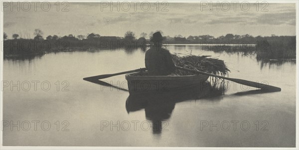 Rowing Home the Schoof-Stuff (from Life and Landscape on the Norfolk Broads, 1886, plate XXI), 1886. Creator: Peter Henry Emerson (British, 1856-1936); Sampson Low, Marston, Seale and Riverton (with T.F. Goodall).