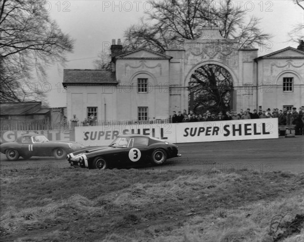 Ferrari 250 SWB spins as Jaguar E type passes. Creator: Unknown.