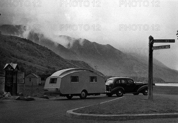 1936 Oldsmobile Eight with caravan in Scotland. Creator: Unknown.