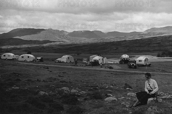 Group of cars and caravans camping in Scottish Highlands 1930's. Creator: Unknown.